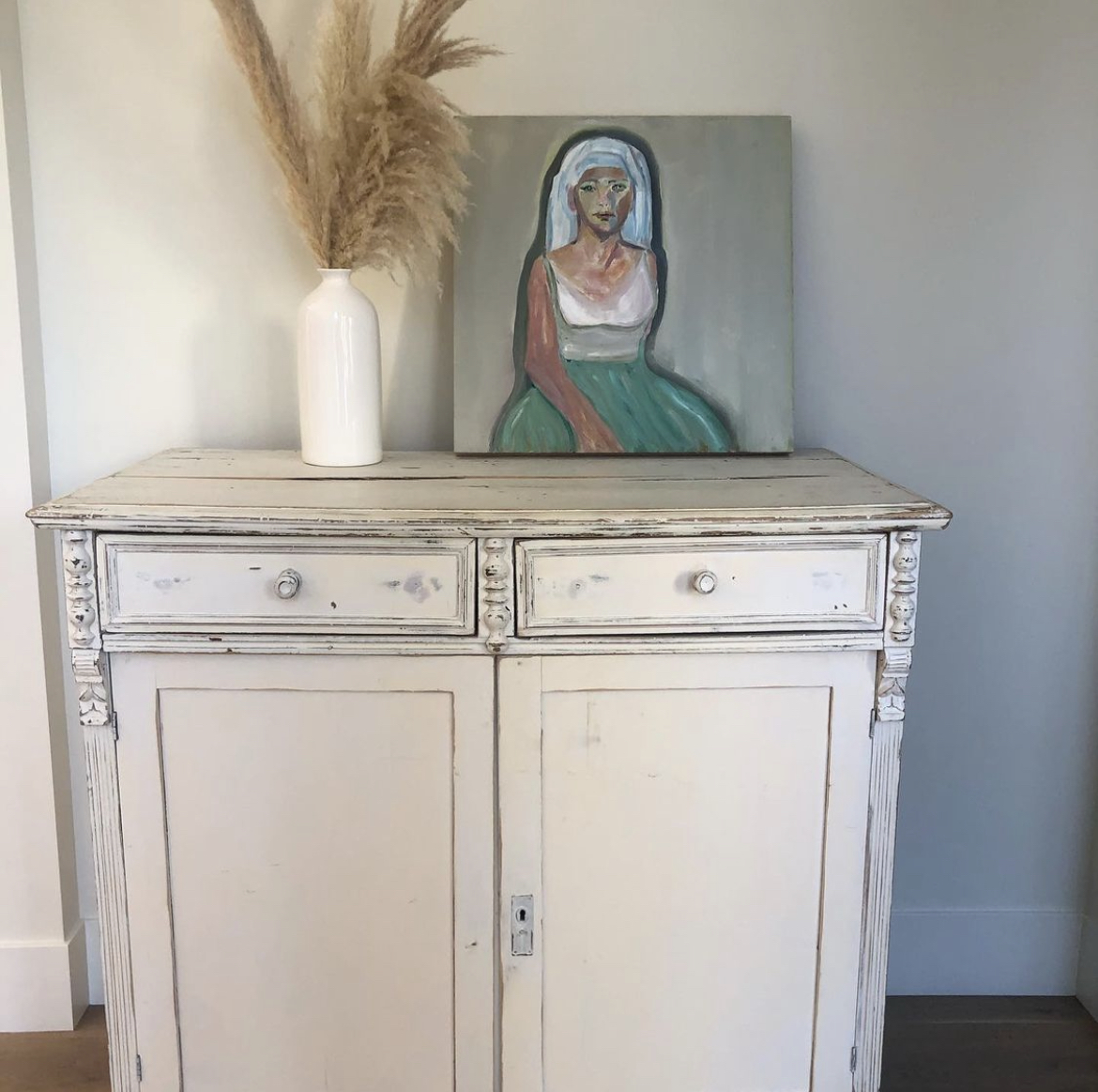 Annie Decamp portrait painting of a woman in a headscarf resting on a cabinet