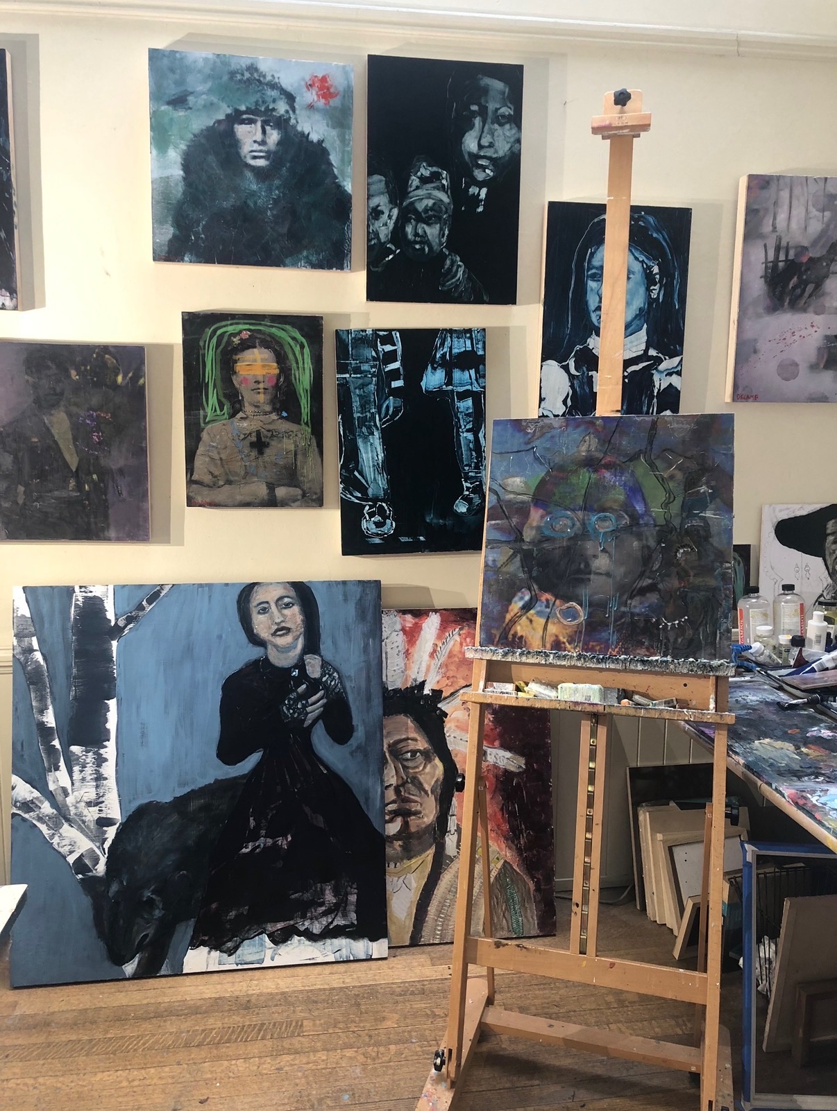 Annie Decamp's studio, paintings and easel in a corner of the workspace.
